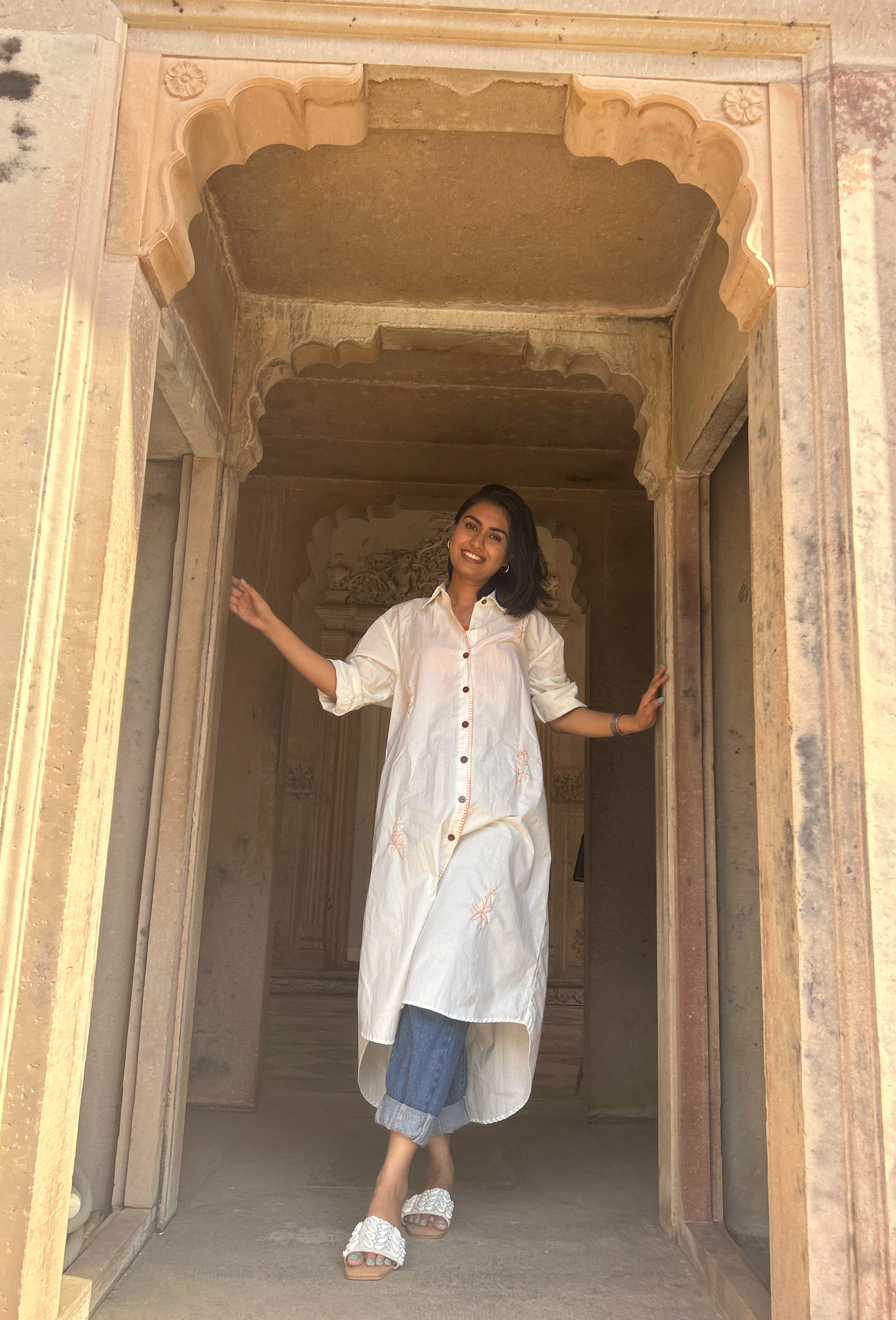 BYASH BASANTI Khadi Collection — model in ivory shirt dress at Rajasthan archway